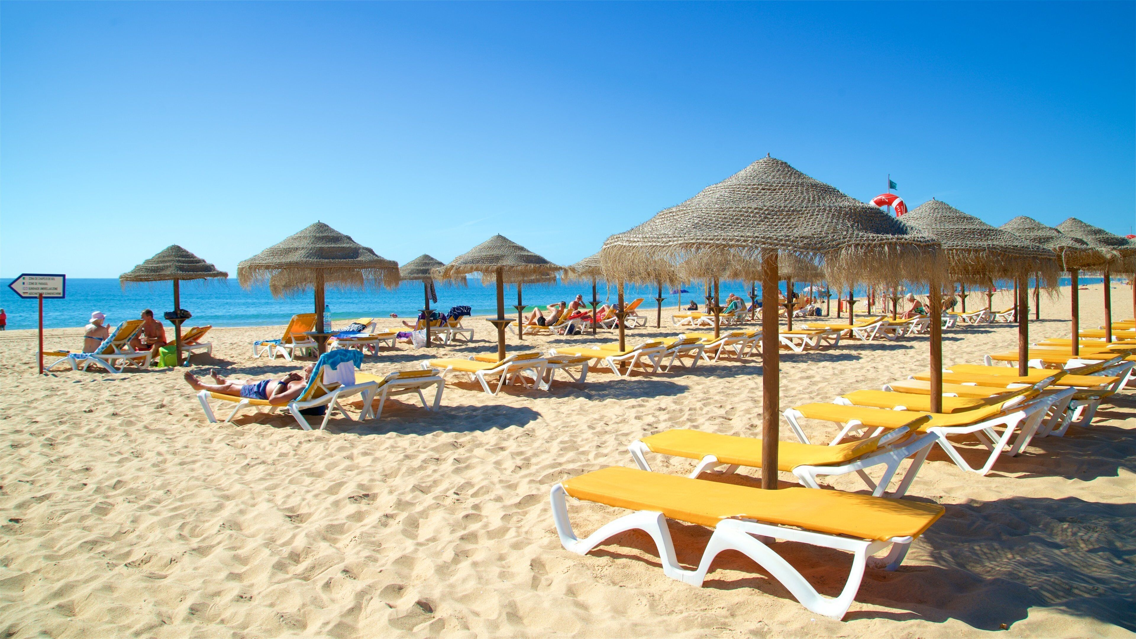 Alvor Beach which includes general coastal views, a sandy beach and tropical scenes