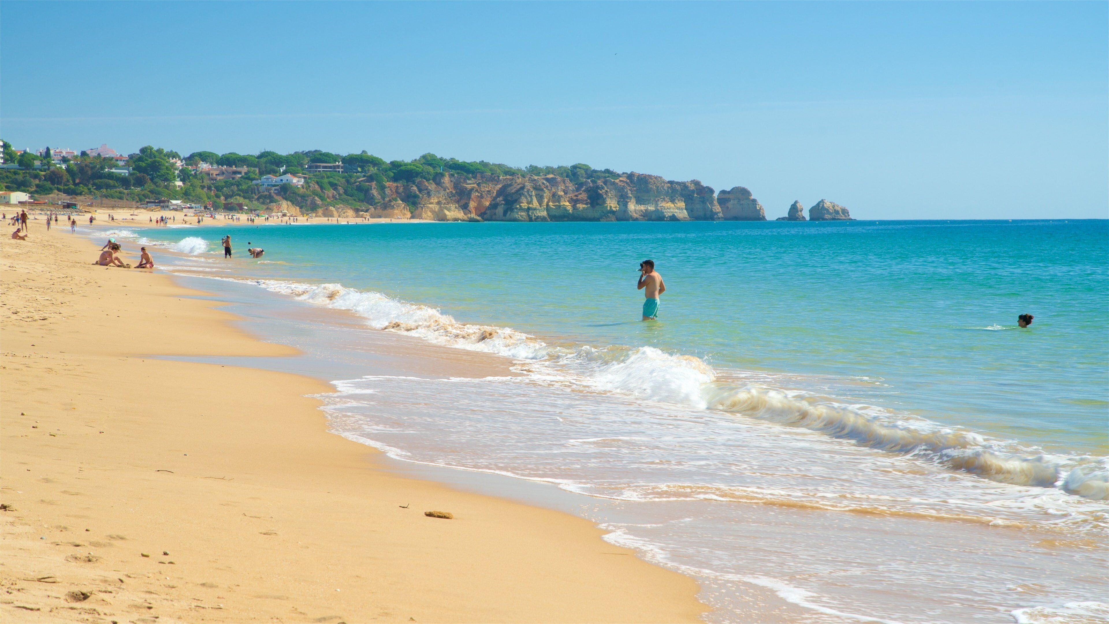 Alvor Beach showing a sandy beach, swimming and general coastal views