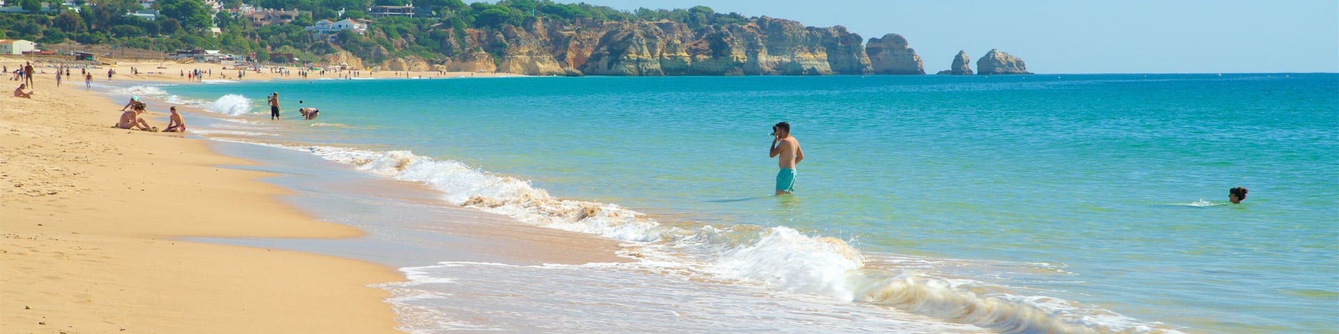 Alvor Beach showing a sandy beach, swimming and general coastal views