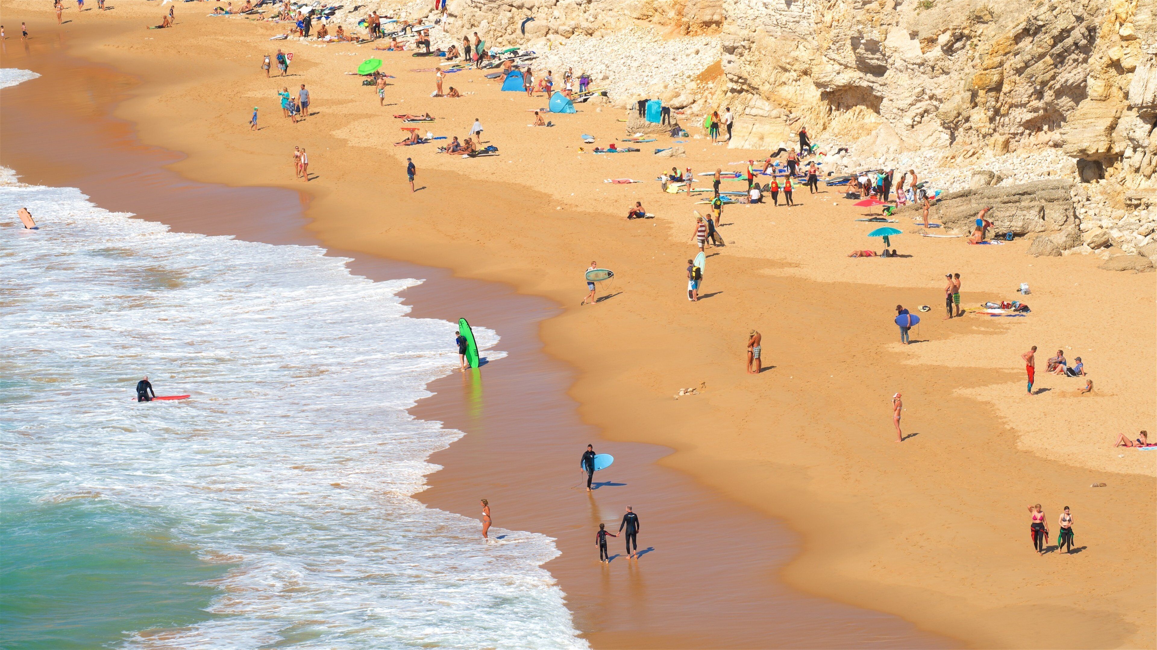 Tonel Beach featuring a sandy beach and general coastal views as well as a small group of people