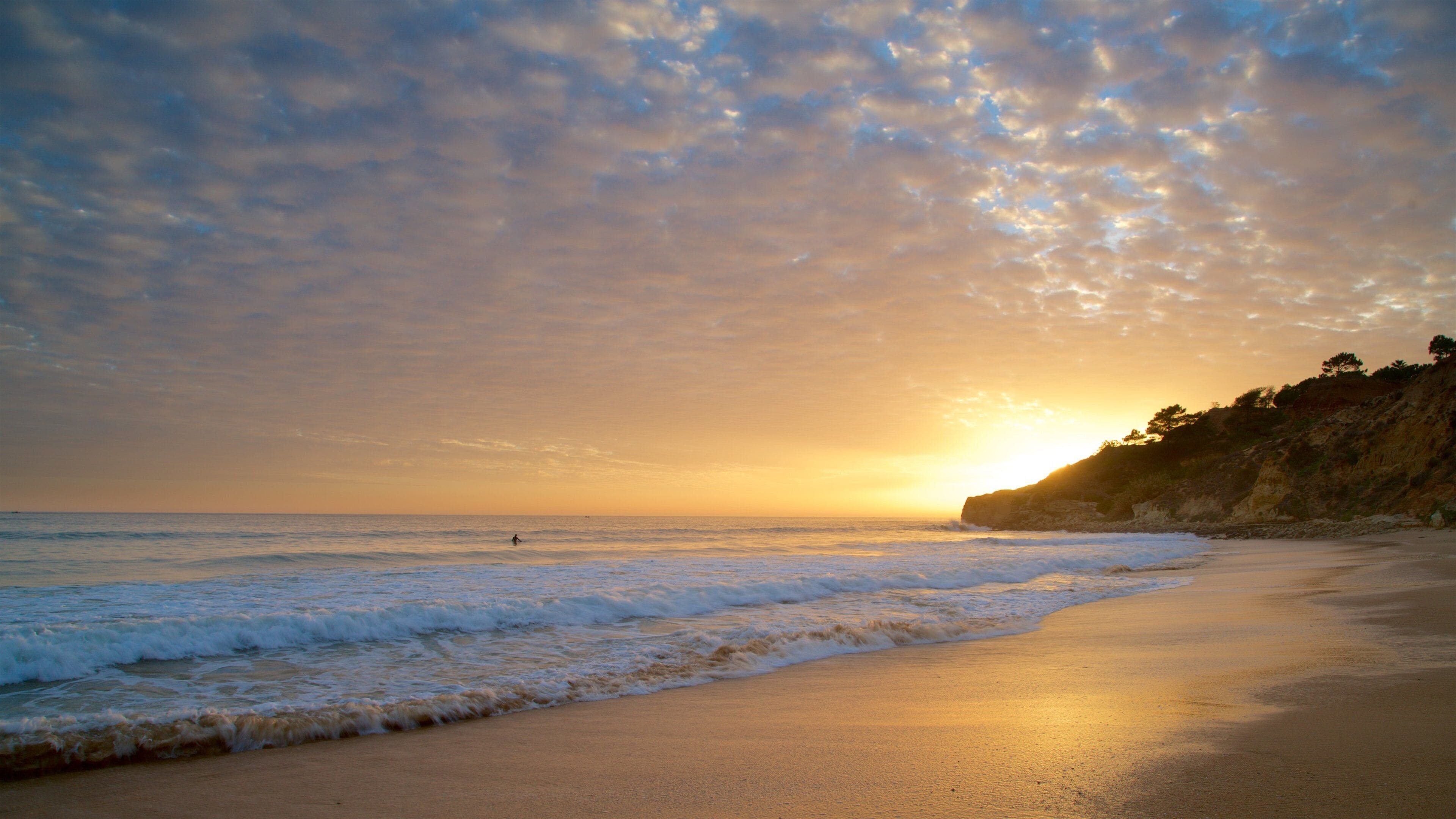 Falesia Beach showing rocky coastline, general coastal views and a sandy beach
