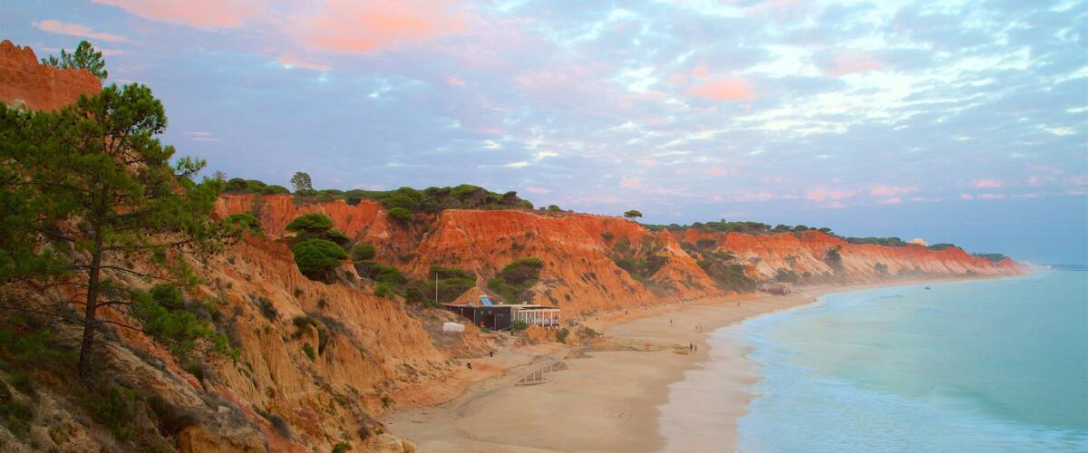 Falesia Beach showing rugged coastline, a sunset and general coastal views