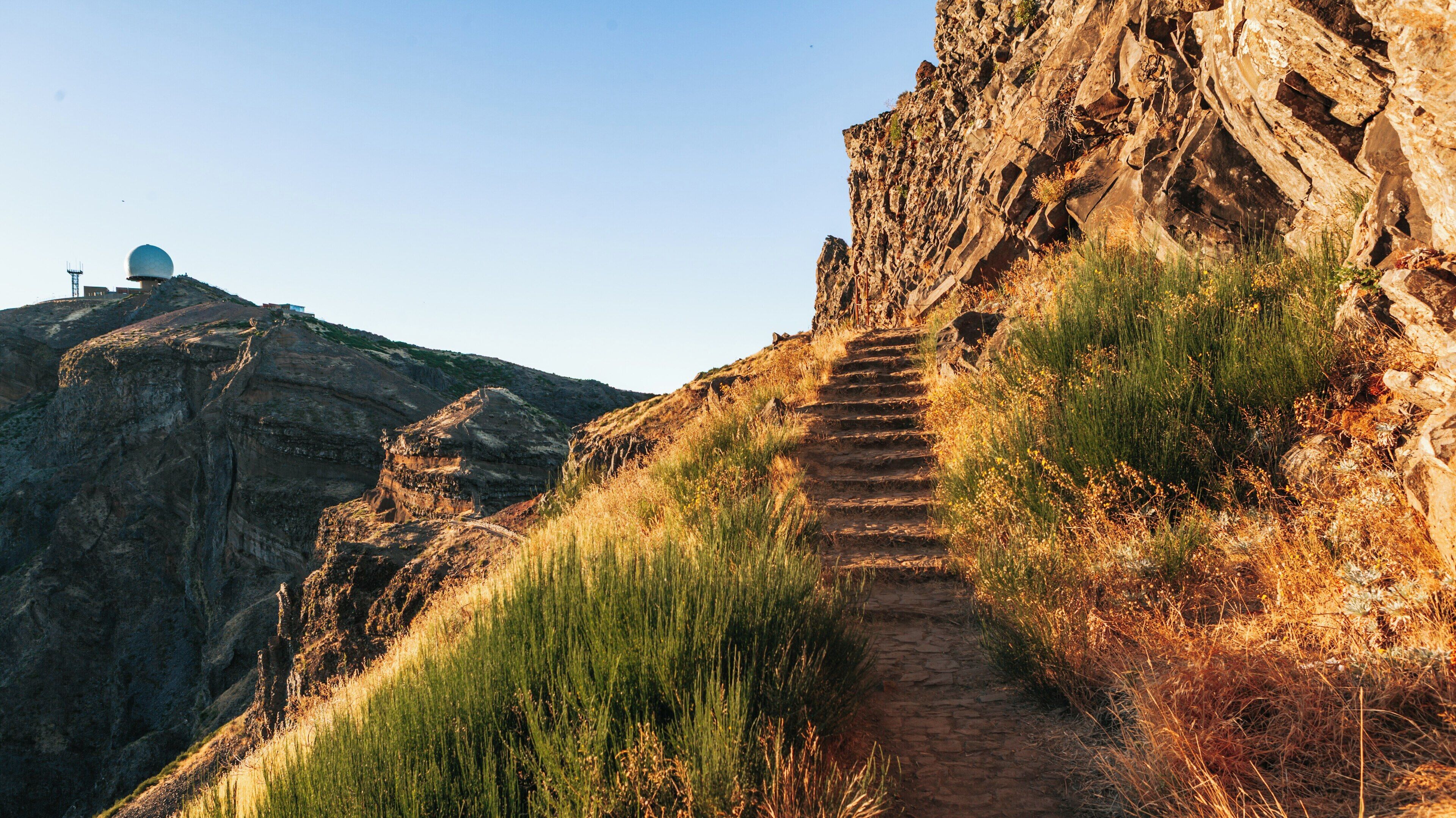 Stunning panorama of Pico do Ariero in Madeira showcasing rocky terrain and golden hues during sunset