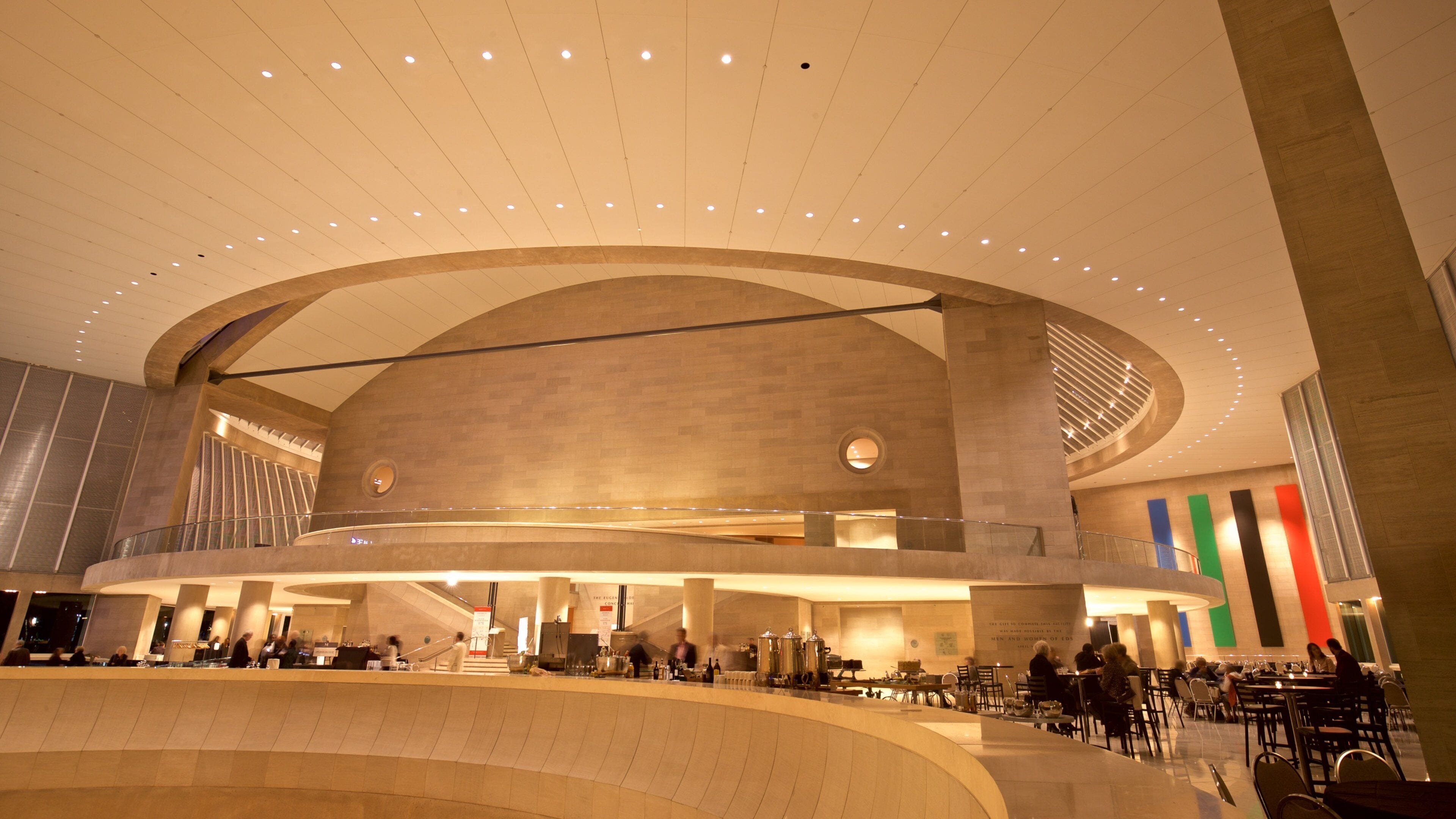 A spacious, modern interior with a curved ceiling and multiple levels.