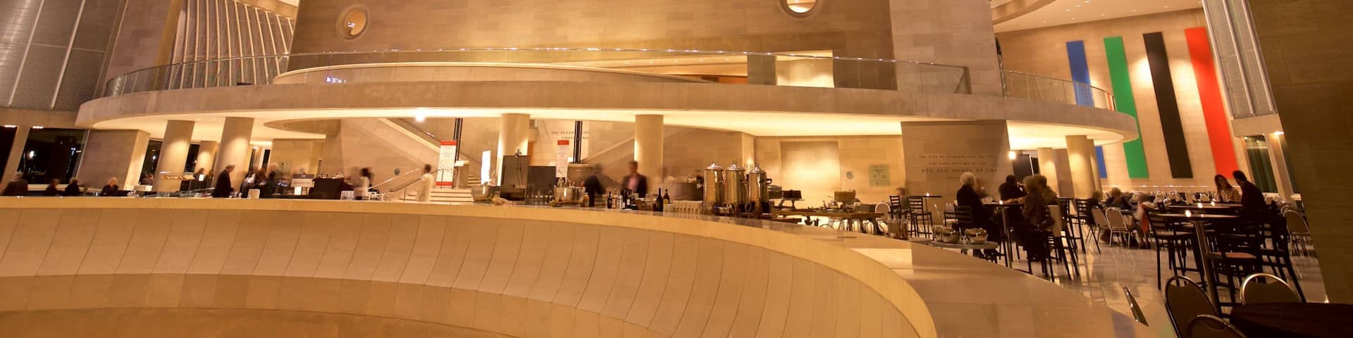 A spacious, modern interior with a curved ceiling and multiple levels.