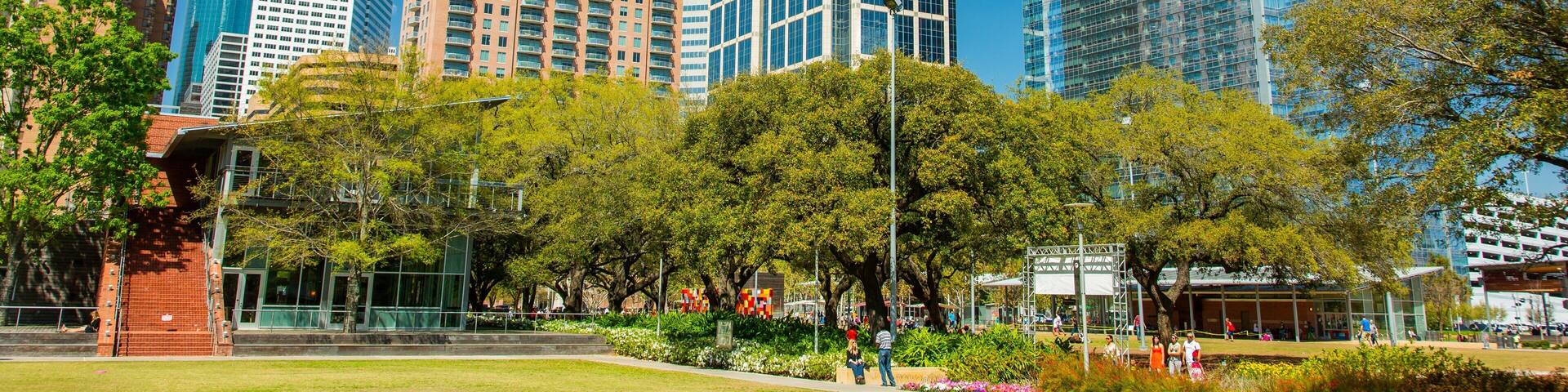 Discovery Green showing a high rise building, a garden and street scenes