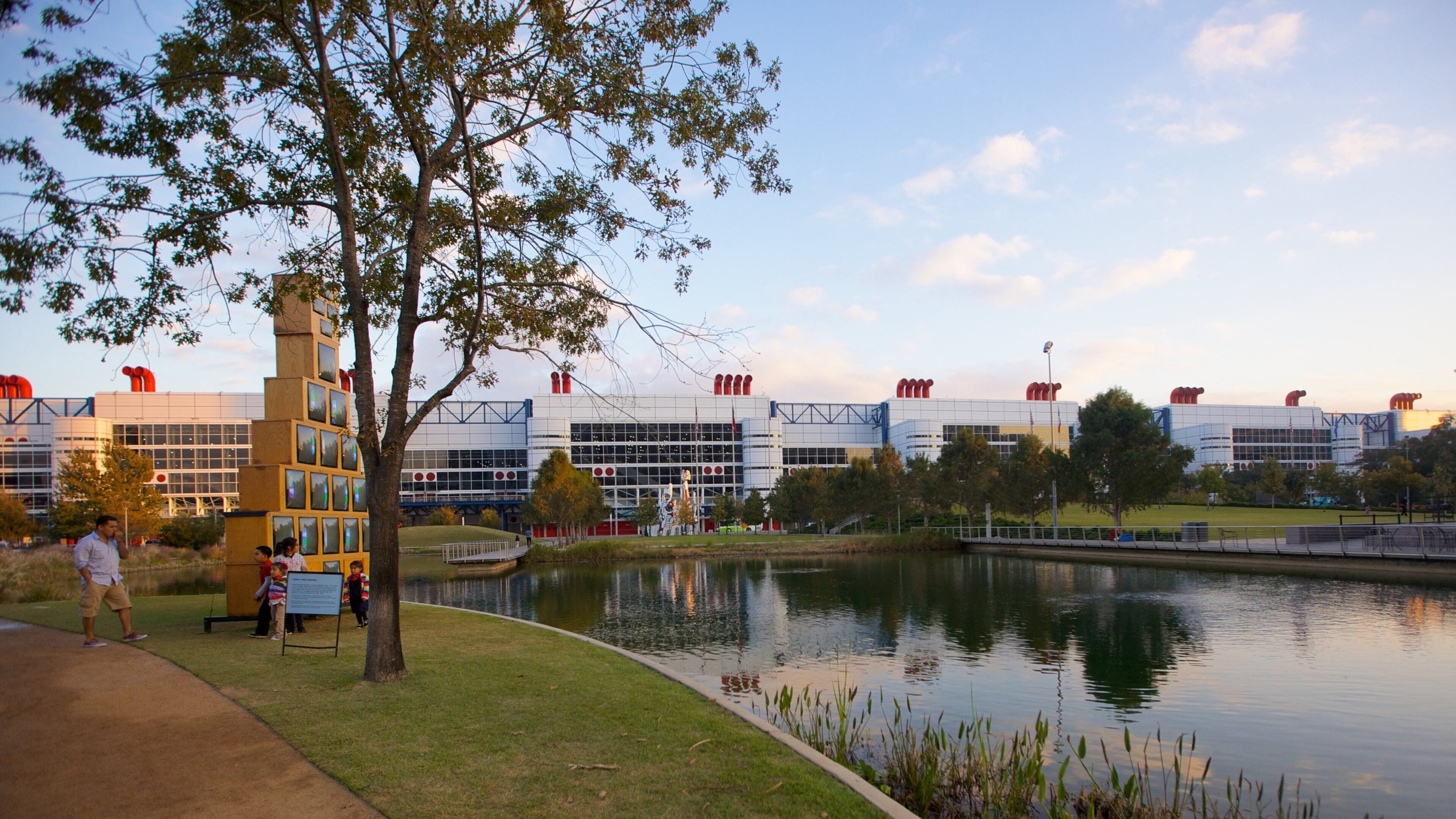 Visitors enjoy a sunny day at Discovery Green Park in Houston Texas with scenic views and vibrant activities