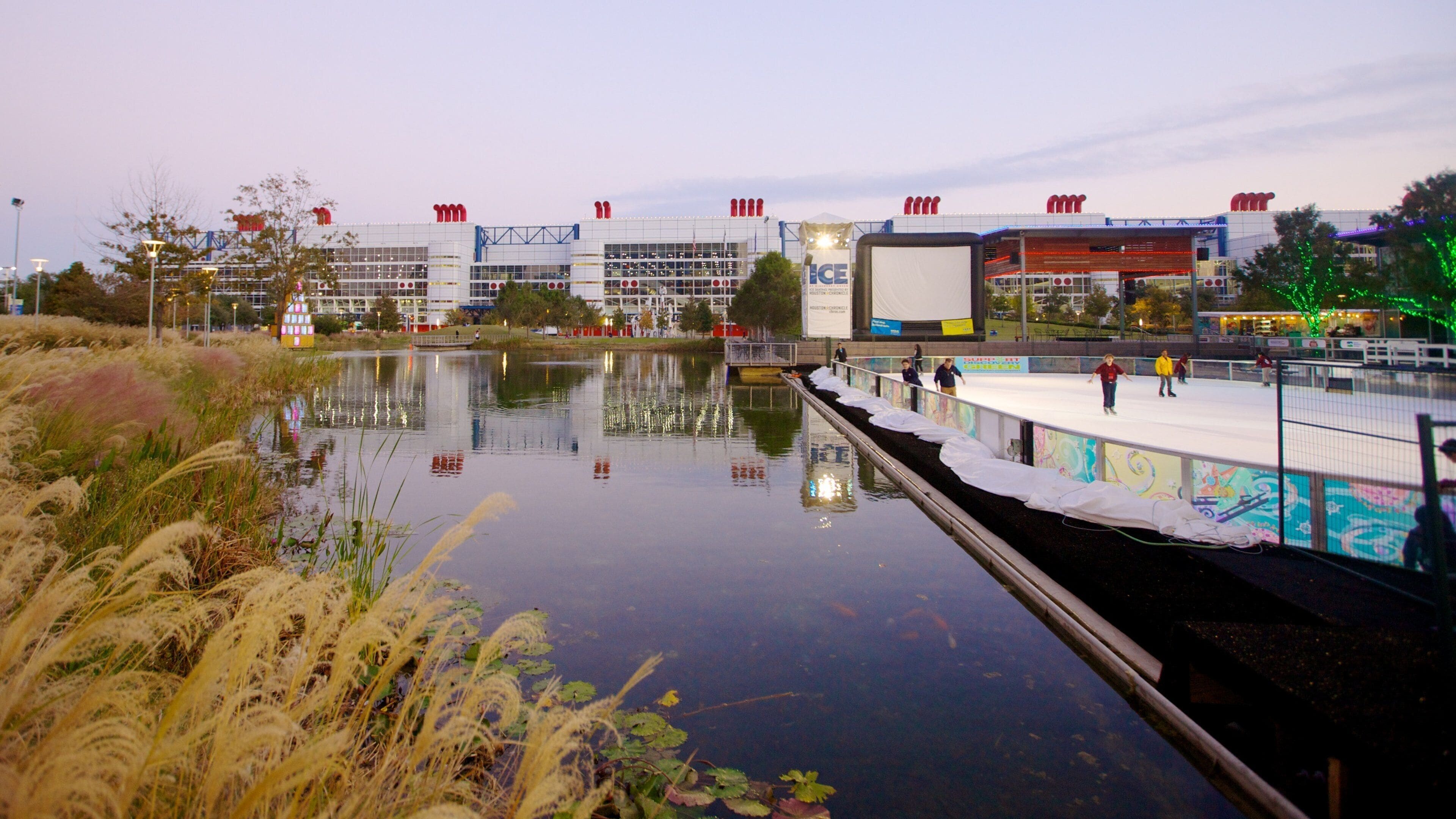 Winter activities by the waterfront at Discovery Green in Houston featuring ice skating and festive decorations