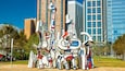 A sculpture garden with abstract art pieces in a city park.
