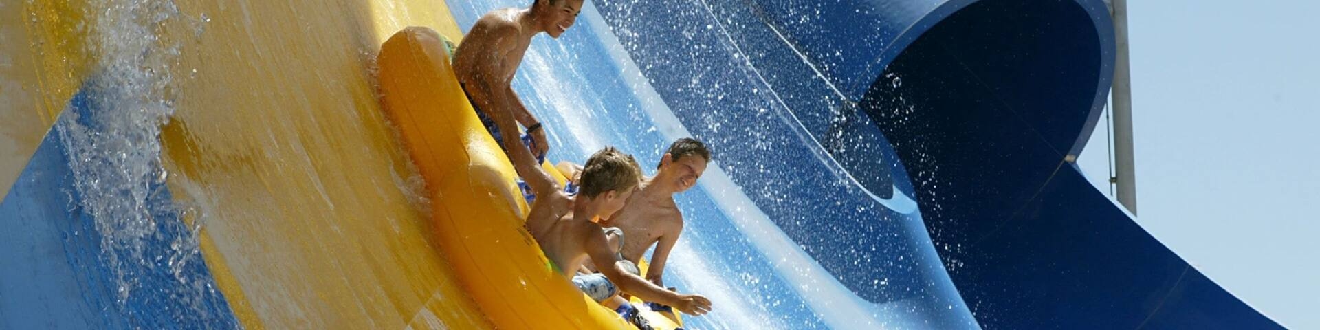 Six Flags Hurricane Harbor featuring a waterpark as well as a small group of people
