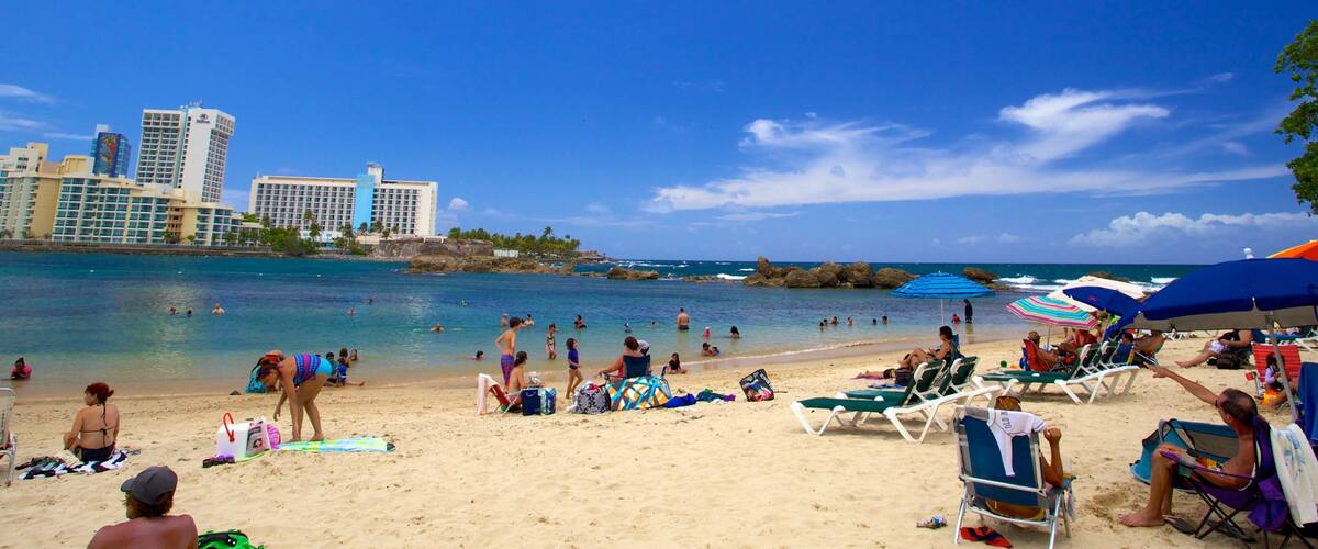 Condado Beach which includes a sandy beach as well as a large group of people