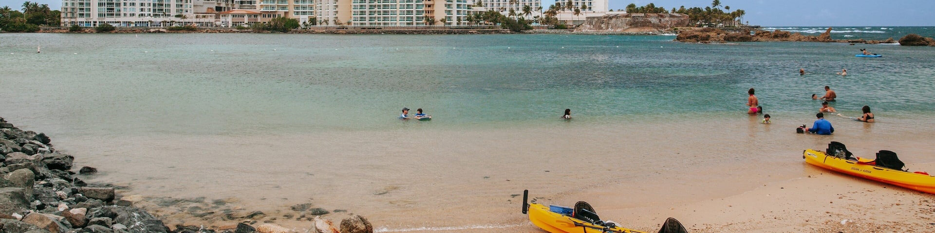 Condado Beach which includes a sandy beach, a coastal town and general coastal views