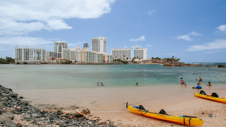 Condado Beach which includes a sandy beach, a coastal town and general coastal views