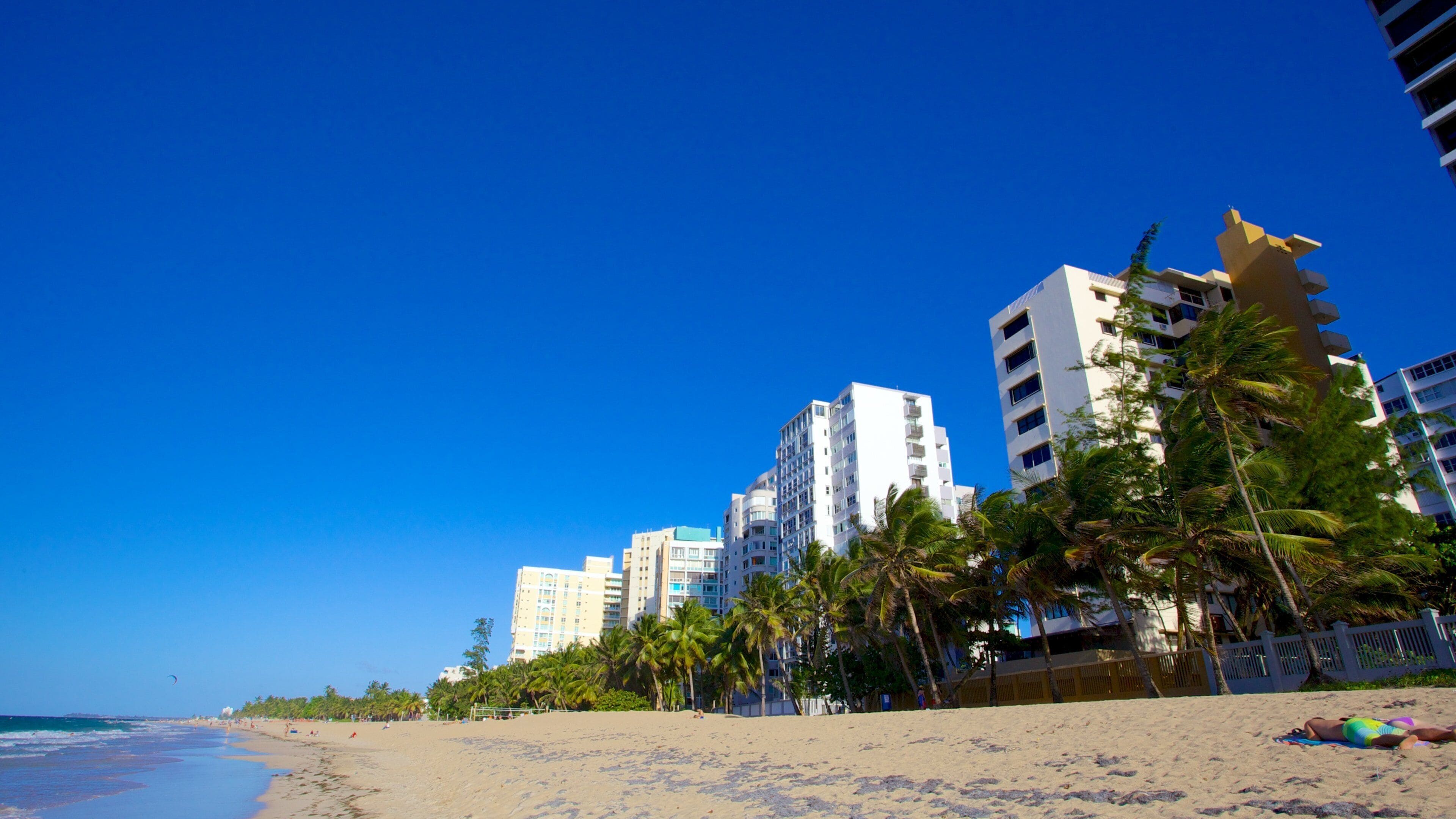 Puerto Rico Island featuring a sandy beach, tropical scenes and a city