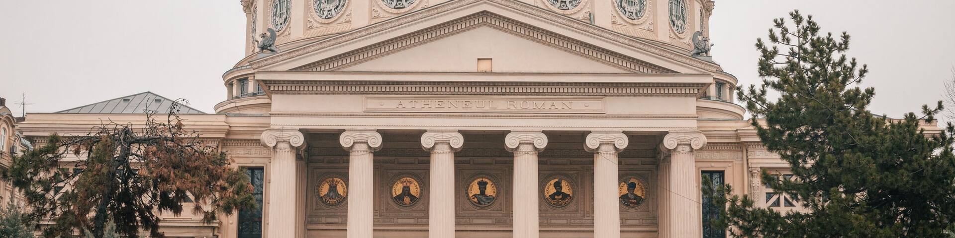 A neoclassical building with a large dome, columns, and statues.