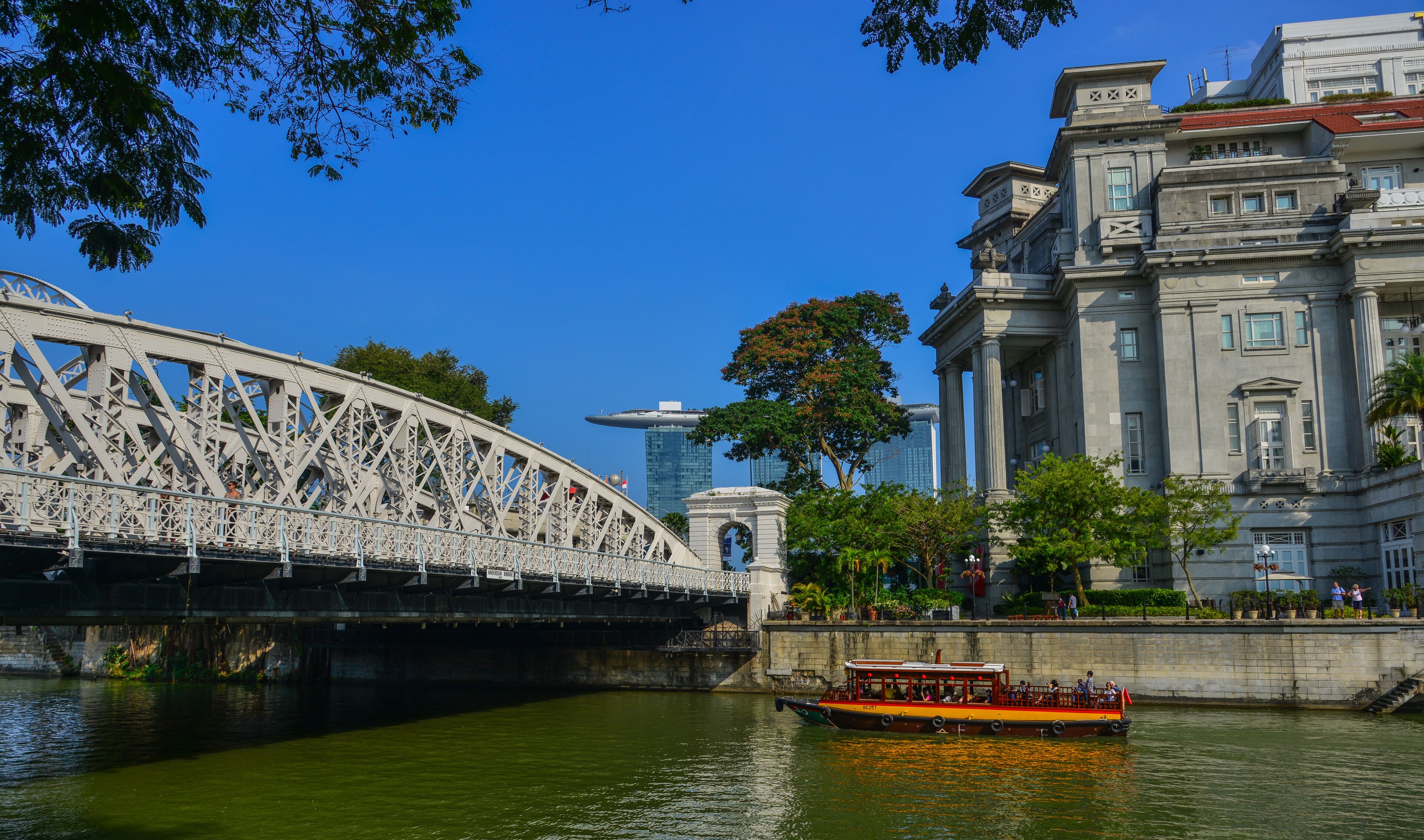 A bridge, a river, and a historic building with columns.