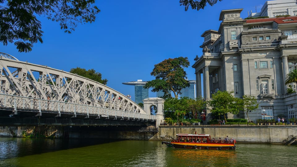 A bridge, a river, and a historic building with columns.