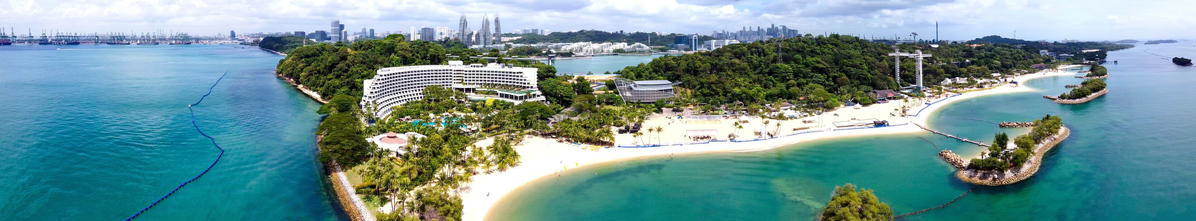 Panoramic aerial view of Siloso Beach and Sentosa Island at sunset, Singapore