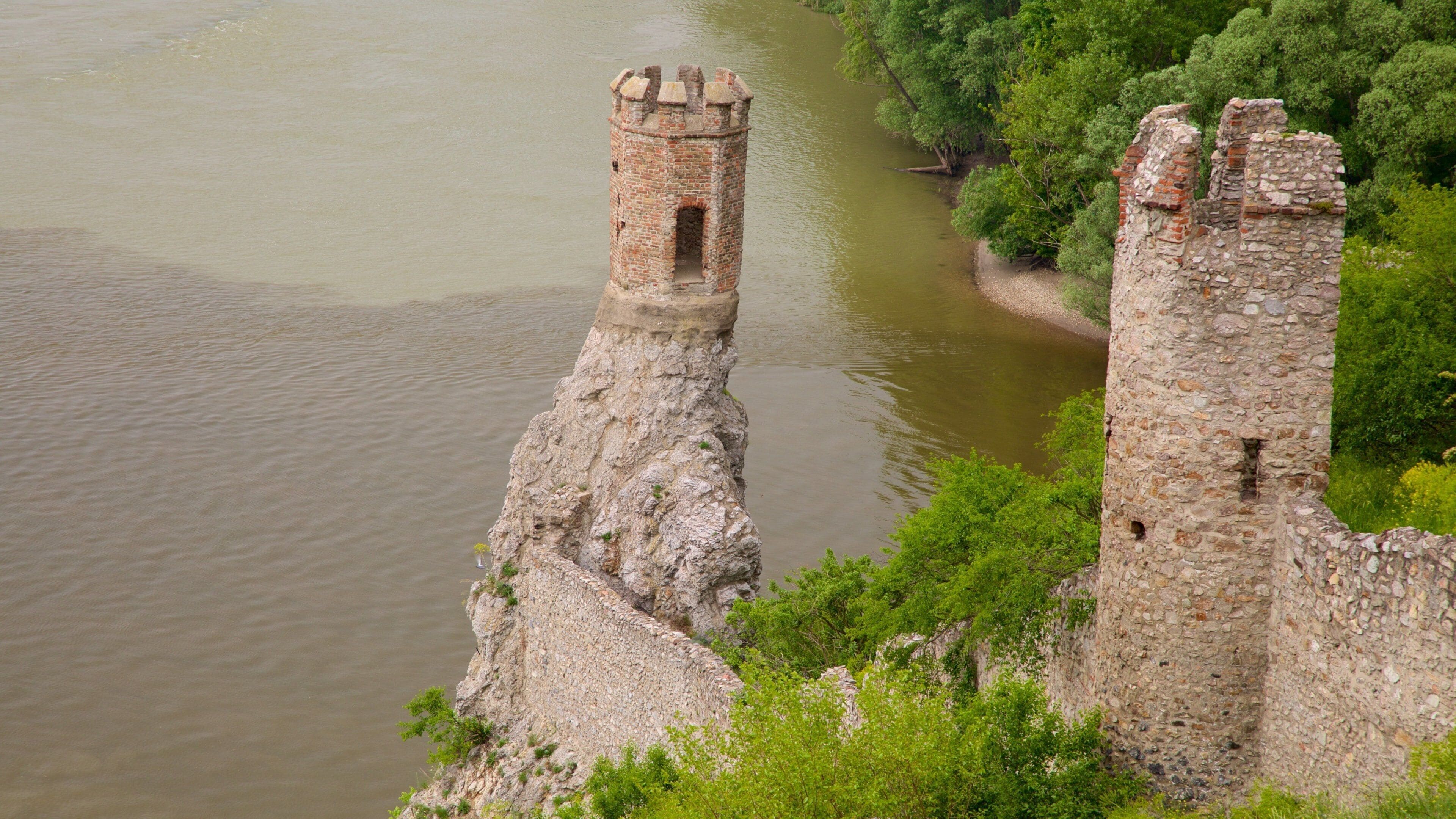 Devin Castle featuring building ruins, a castle and a lake or waterhole