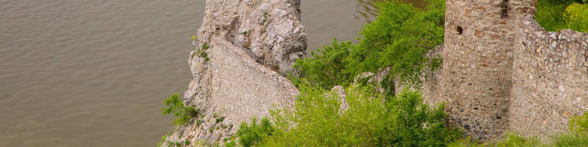 Devin Castle featuring building ruins, a castle and a lake or waterhole