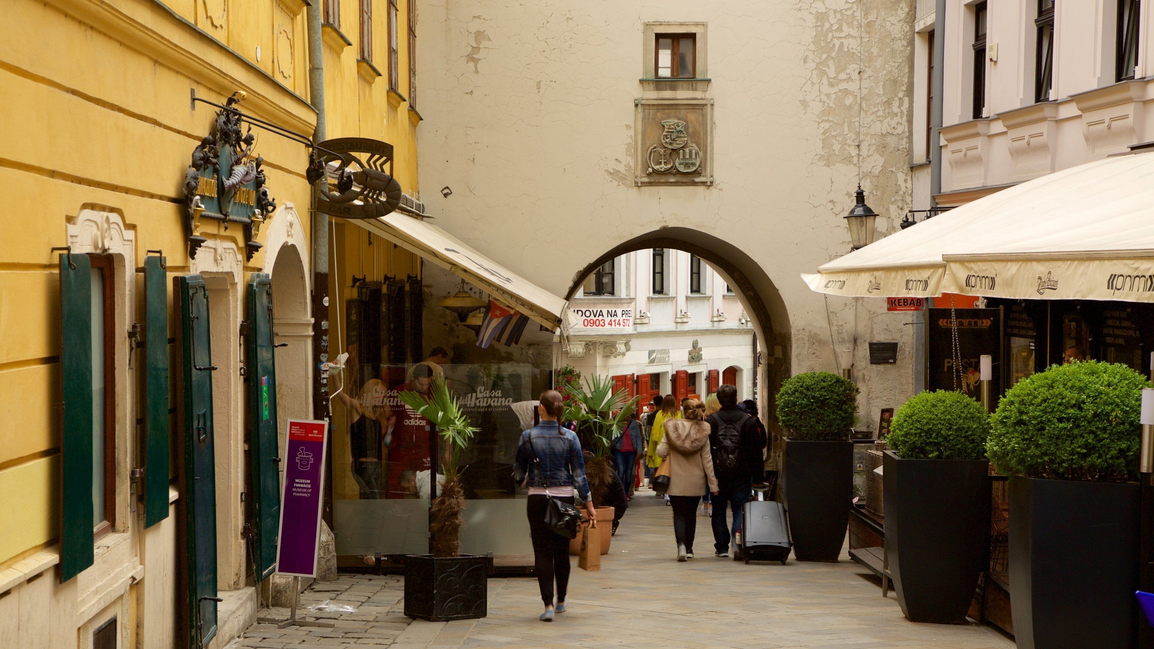 Michael\'s Gate featuring a city and street scenes as well as a small group of people