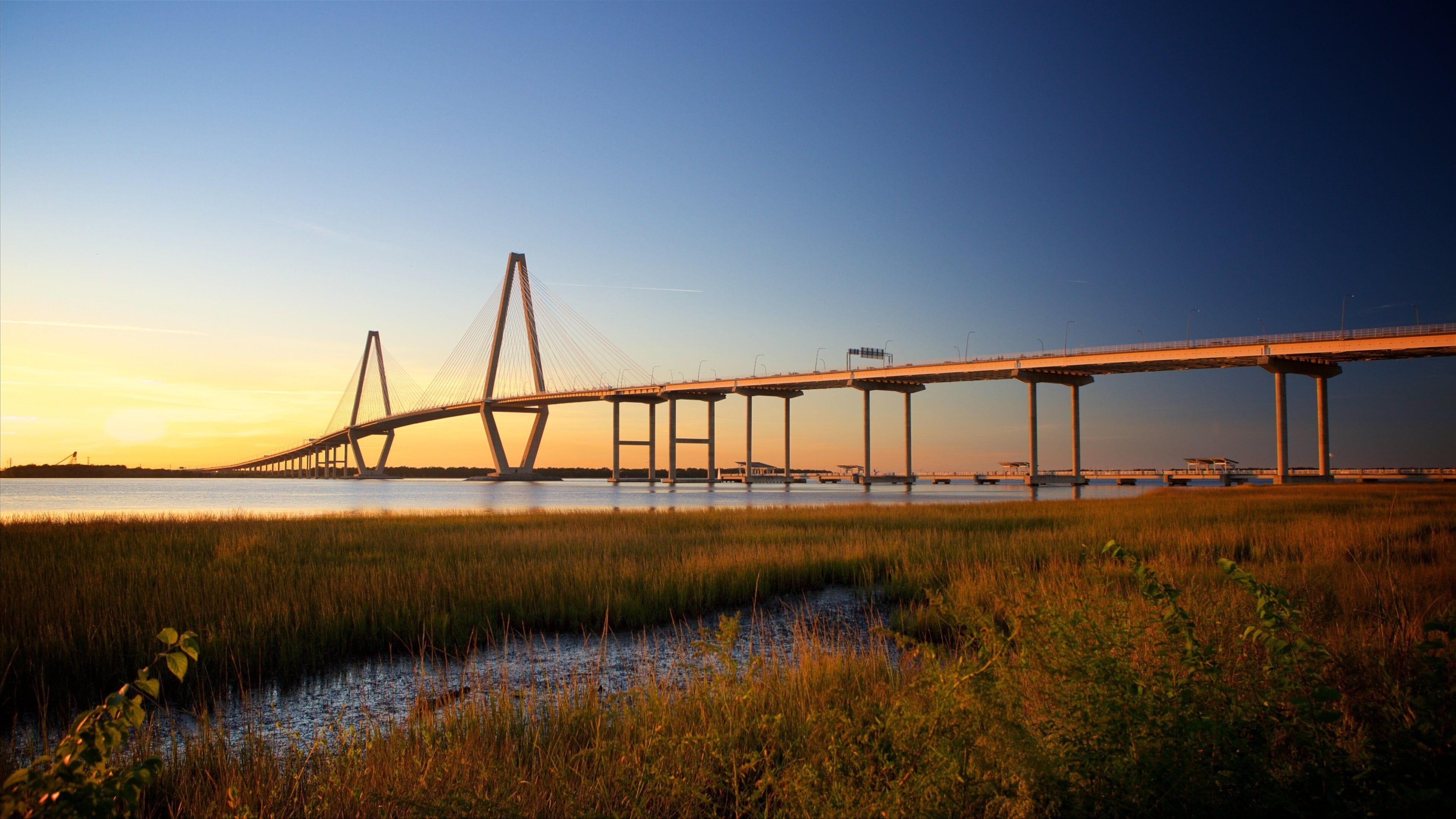 Arthur Ravenel Jr. Bridge featuring a sunset, wetlands and a bridge