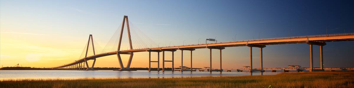 Arthur Ravenel Jr. Bridge featuring a sunset, wetlands and a bridge