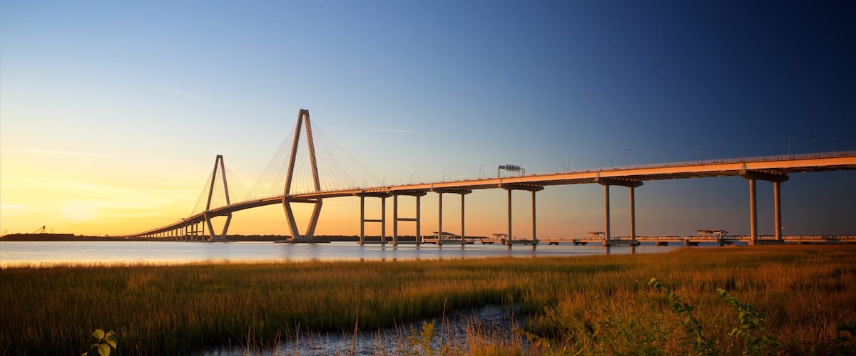 Arthur Ravenel Jr. Bridge featuring a sunset, wetlands and a bridge