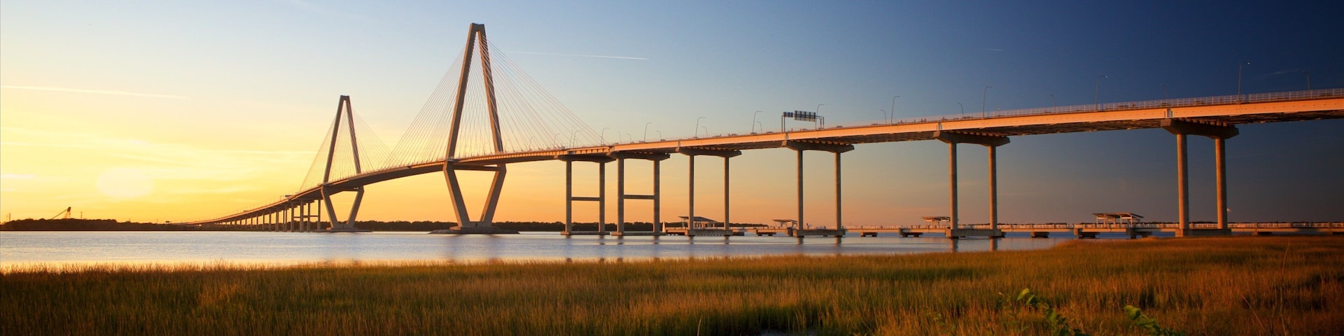 Arthur Ravenel Jr. Bridge featuring a sunset, wetlands and a bridge