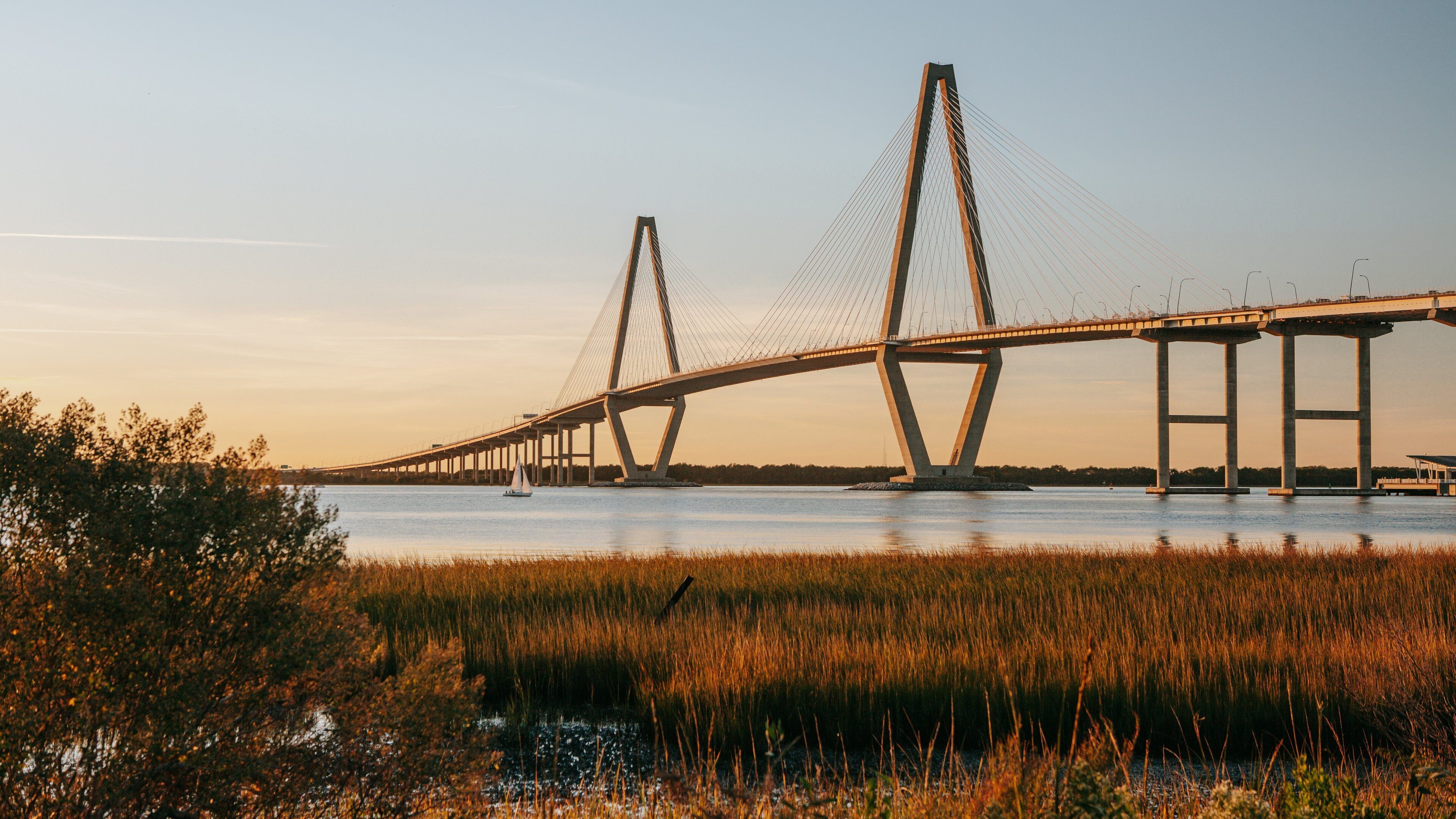 Arthur Ravenel Jr. Bridge showing a river or creek, landscape views and a sunset