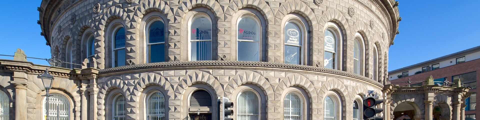 A historic building with ornate stonework and arched windows.