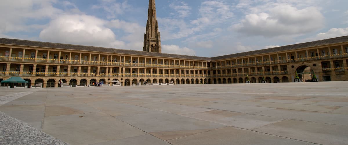 Halifax West Yorkshire UK, 10th May 2019: Photo of the famous Piece Hall in the Blackledge area of Halifax, showing the historic stone build building, taken on a part cloudy sunny day.