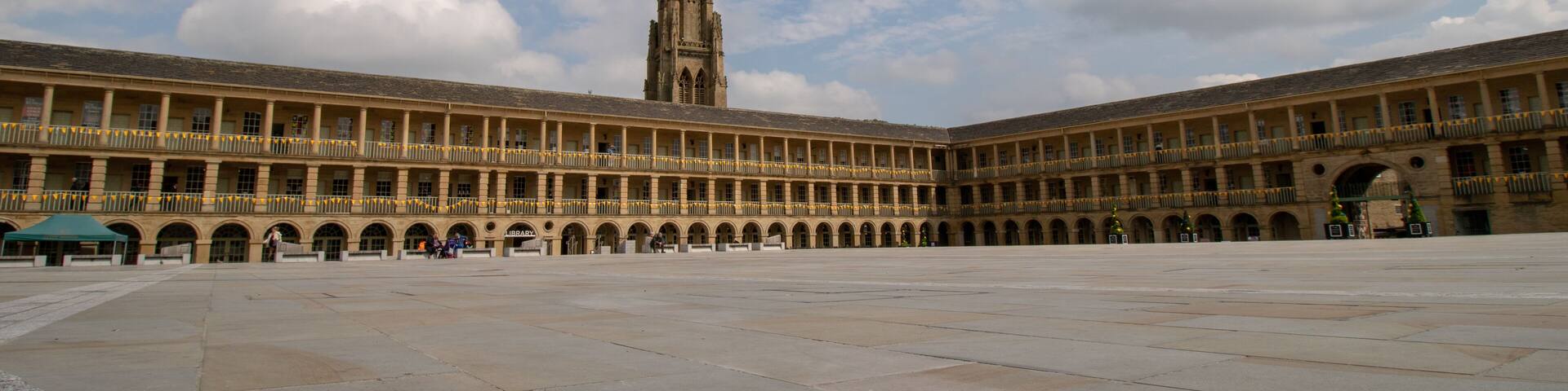 Halifax West Yorkshire UK, 10th May 2019: Photo of the famous Piece Hall in the Blackledge area of Halifax, showing the historic stone build building, taken on a part cloudy sunny day.