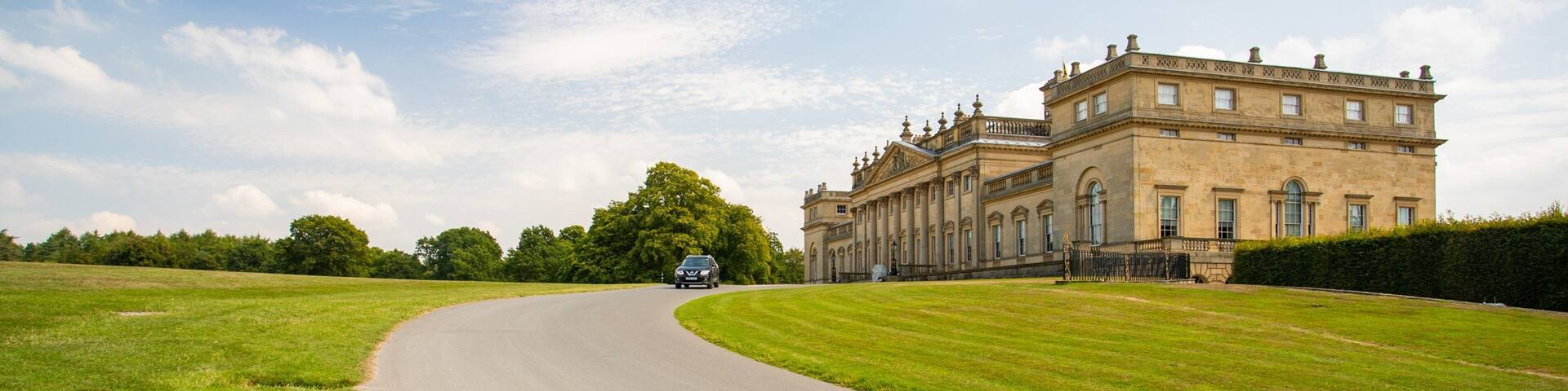 Harewood House featuring heritage architecture, a sunset and a park