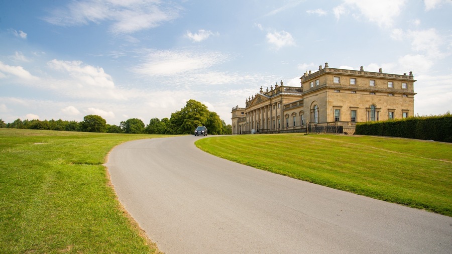 Harewood House featuring heritage architecture, a sunset and a park