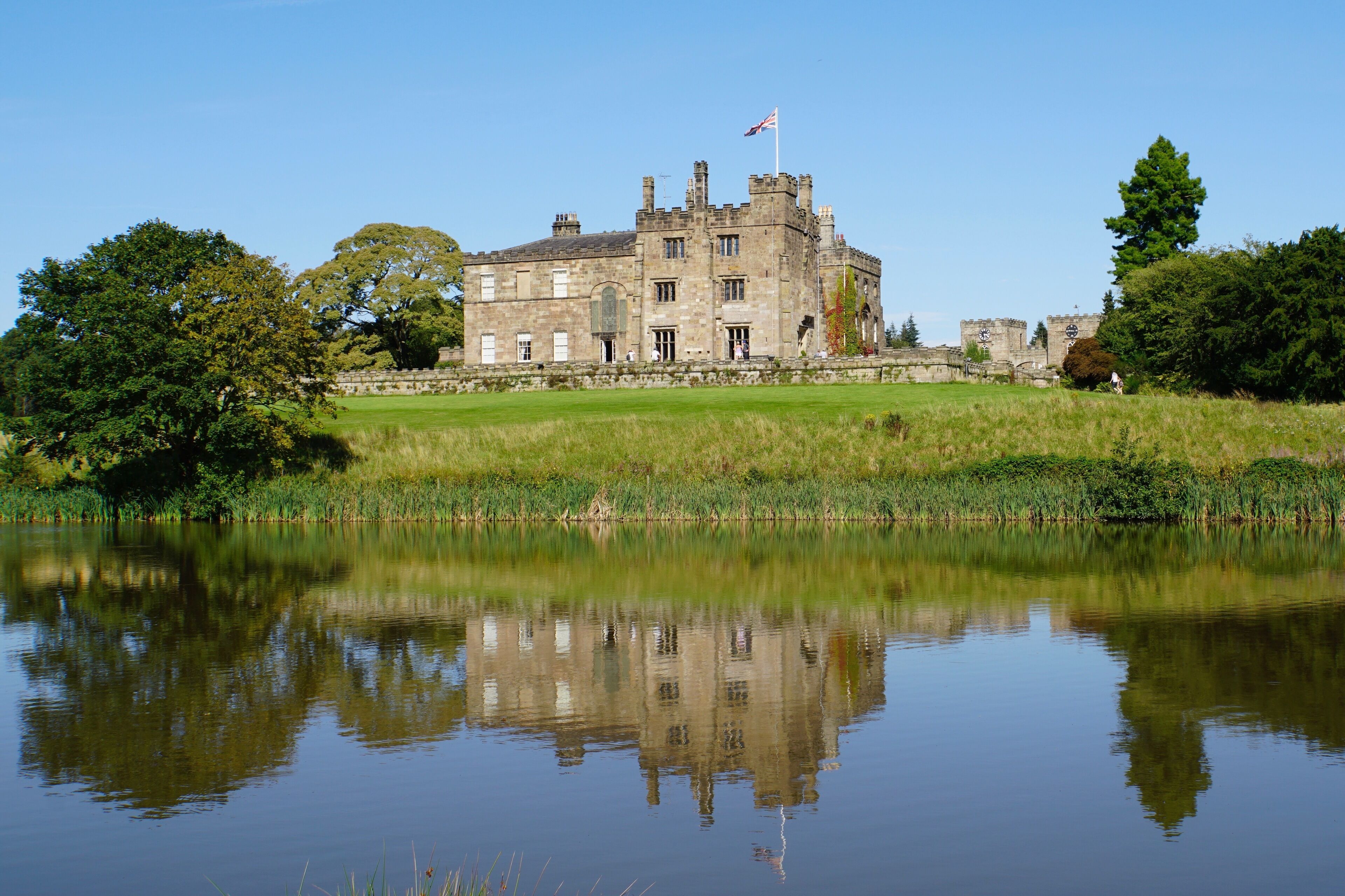 As the sun shines over Ripley Castle (seat of the Ingoldby family), Ripley, North Yorkshire, UK (Aug 2019).