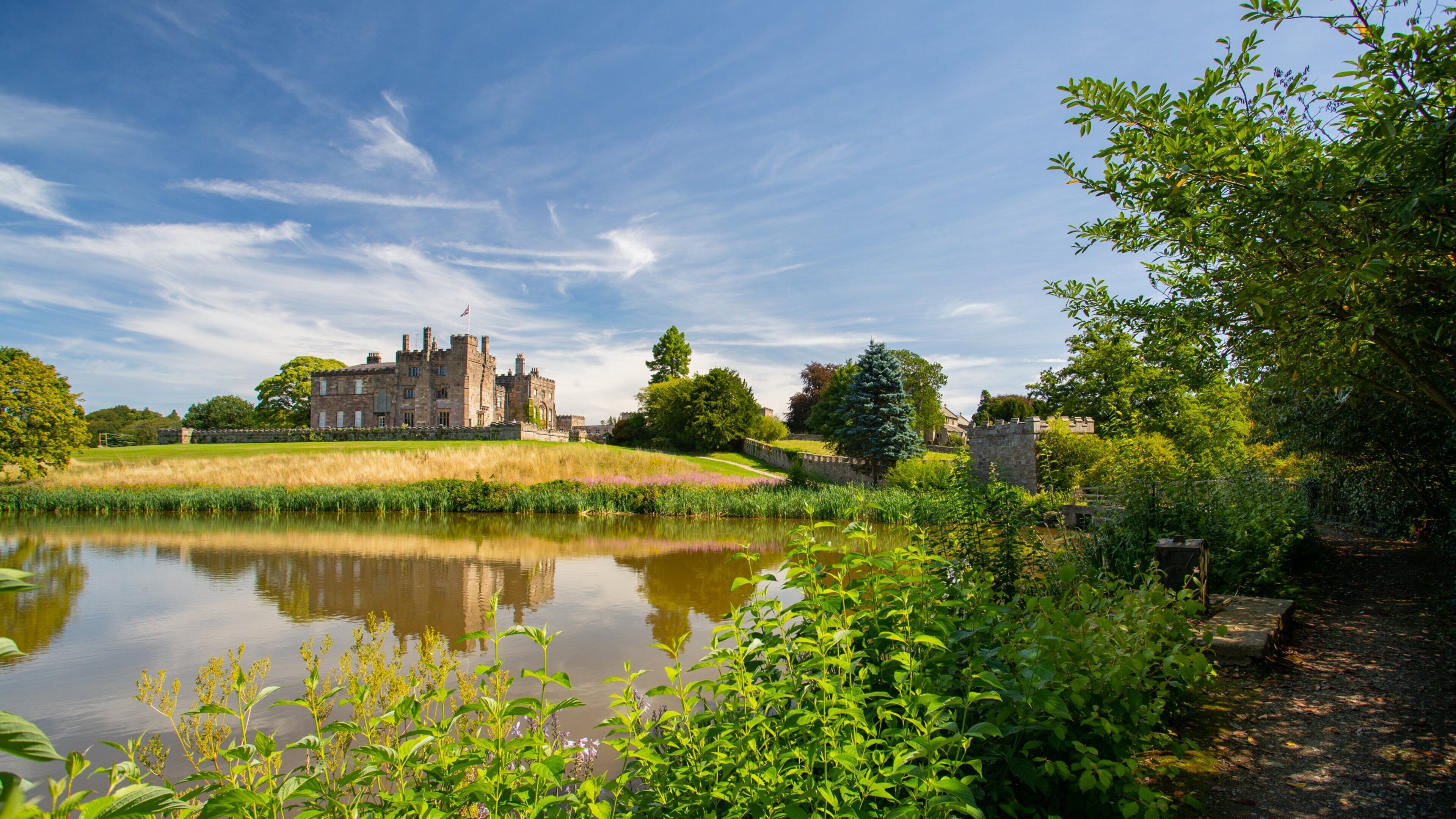Ripley Castle and Gardens which includes heritage architecture, a lake or waterhole and chateau or palace