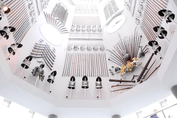 A museum exhibit with various historical weapons and armor.