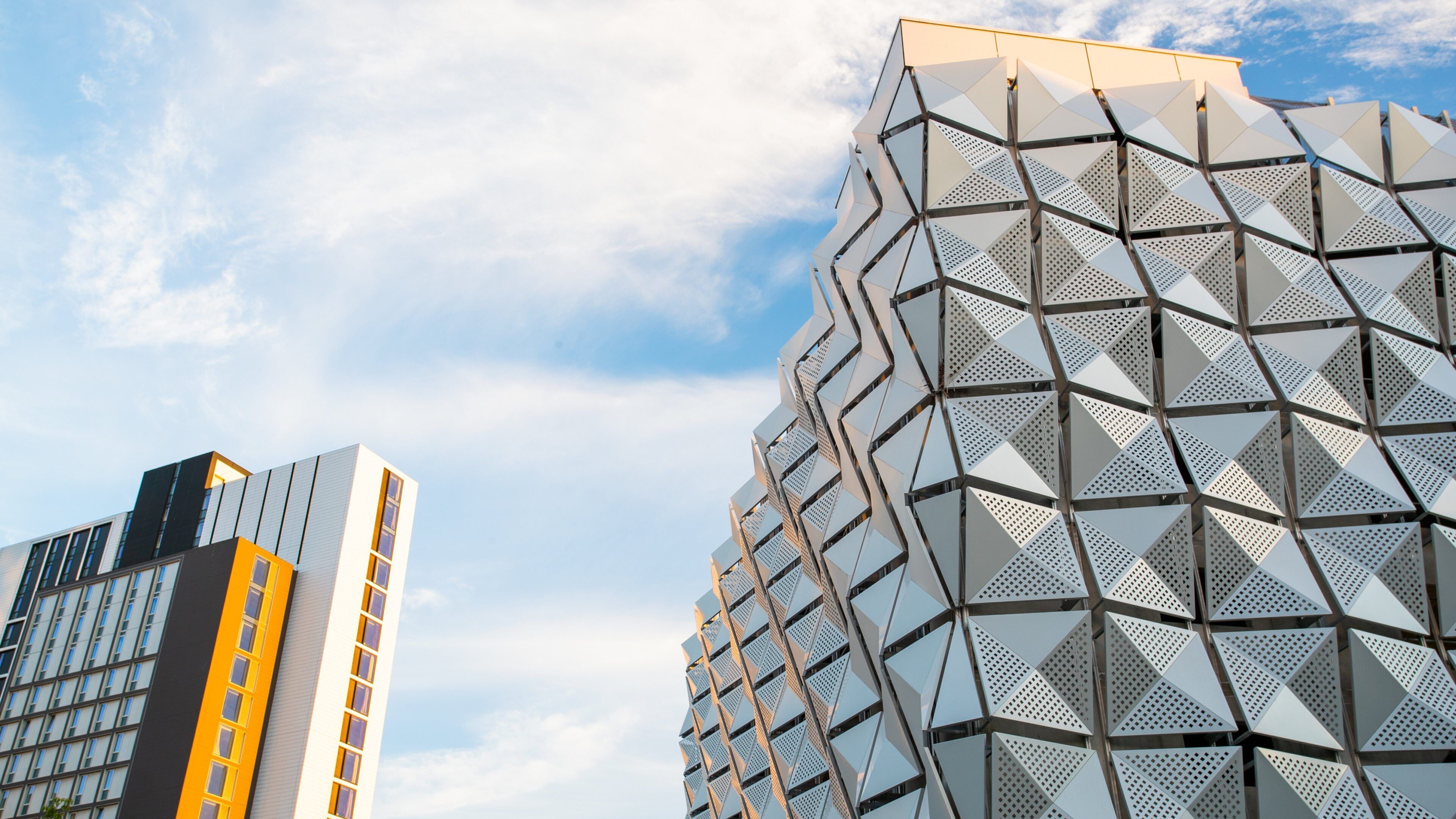 University of Leeds featuring modern architecture and a sunset