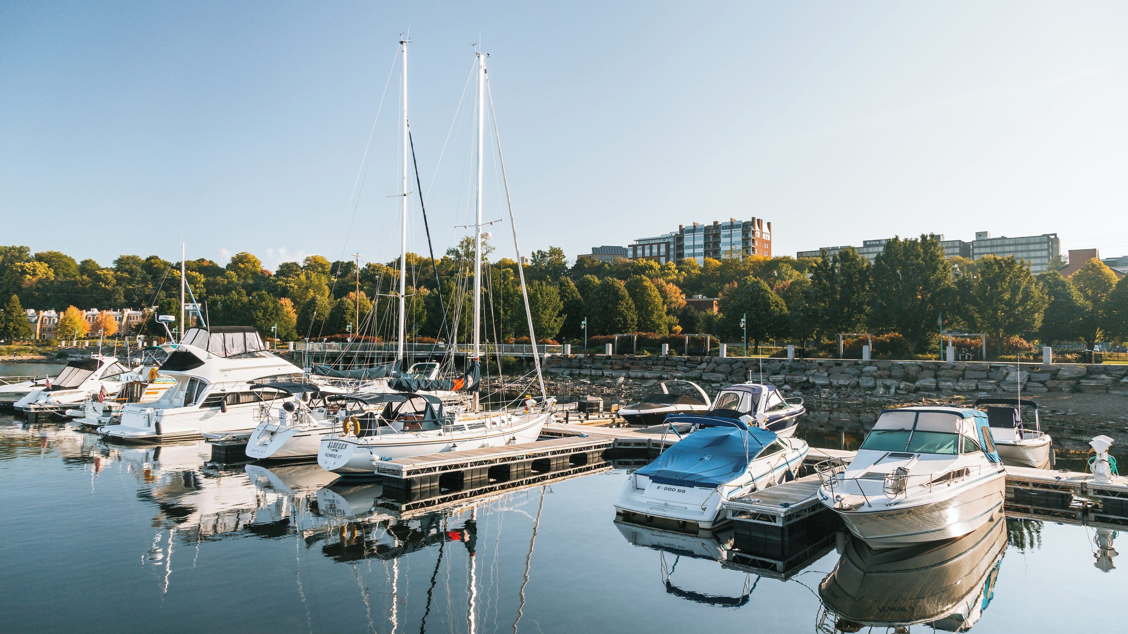 Serene waterfront at Burlington, Vermont with boats docked under clear skies