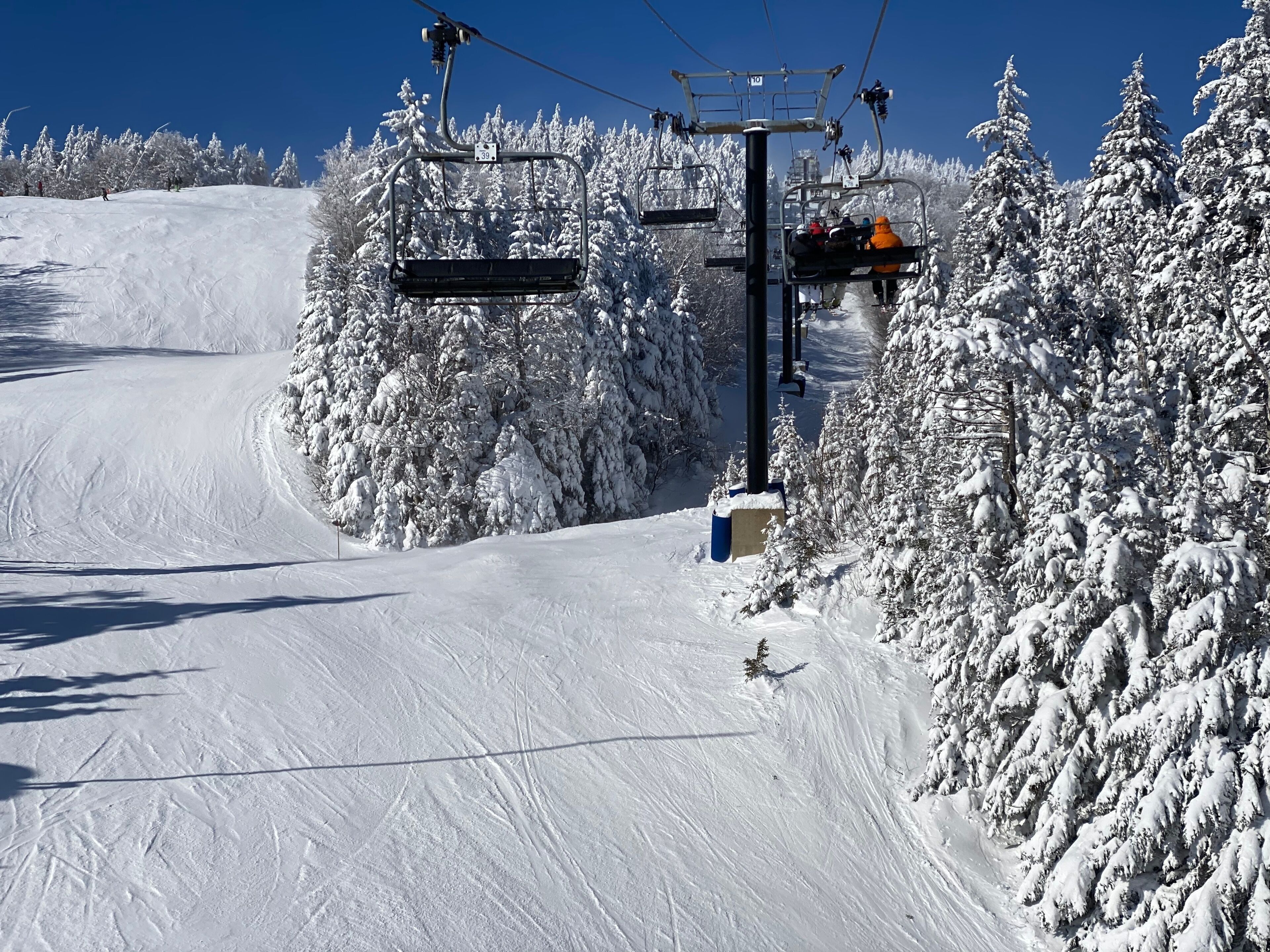 Ski chair lifts at Okemo mountain ski resort at sunny winter day in Vermont USA