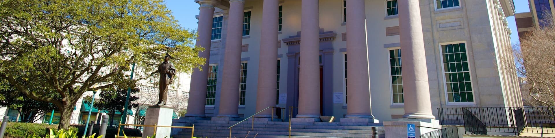 A neoclassical building with a dome and columns, named "The MacArthur Memorial."