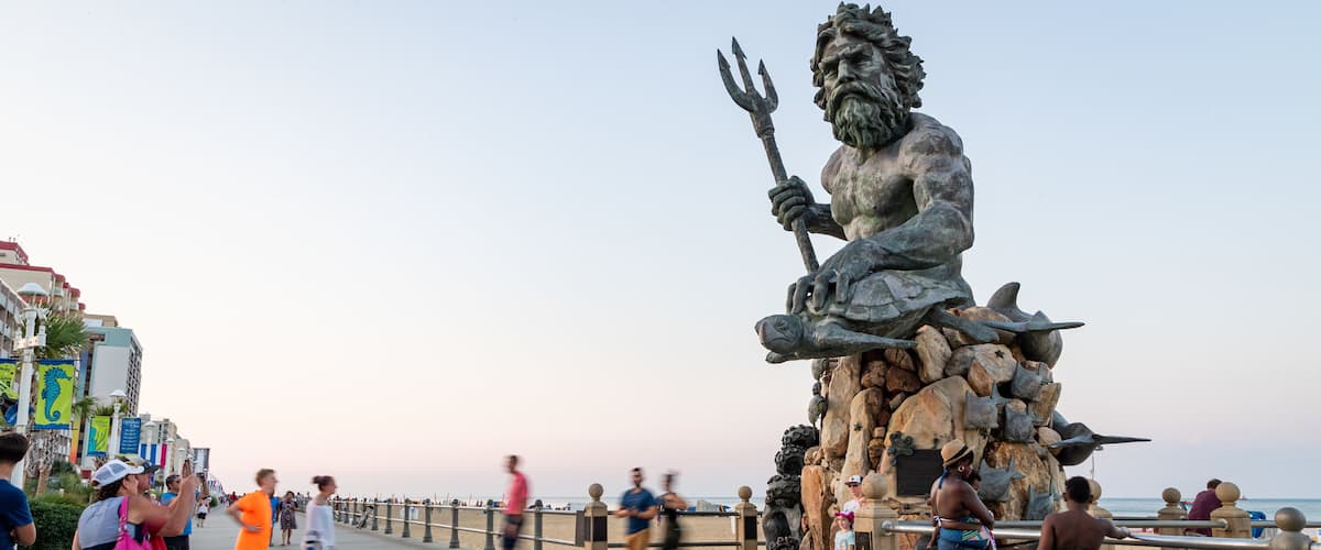 Neptune Statue which includes a sunset, street scenes and a statue or sculpture