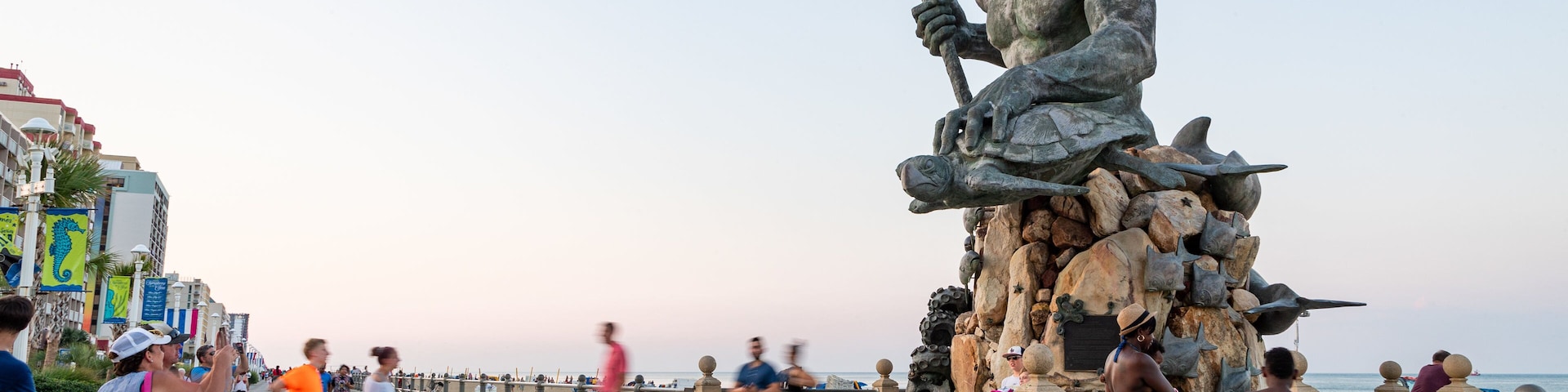 Neptune Statue which includes a sunset, street scenes and a statue or sculpture