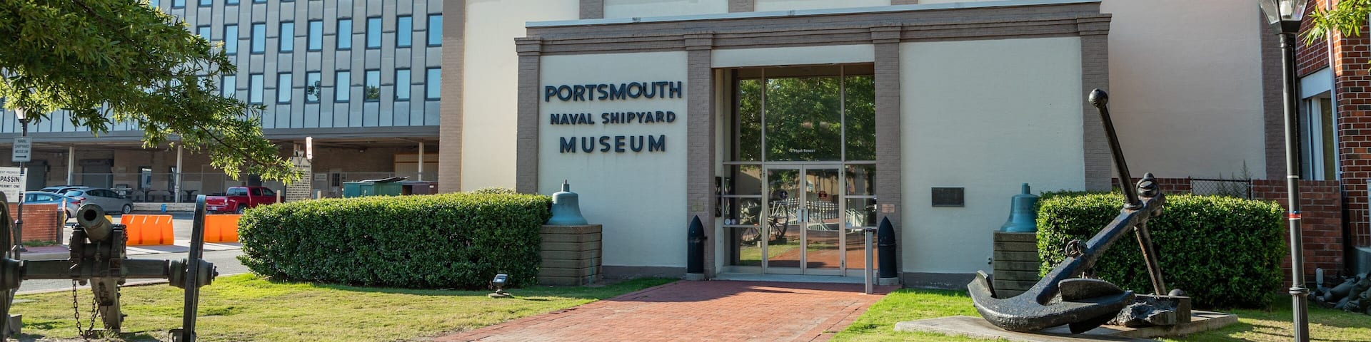 A building labeled "Portsmouth Naval Shipyard Museum" with a brick pathway leading to the entrance.