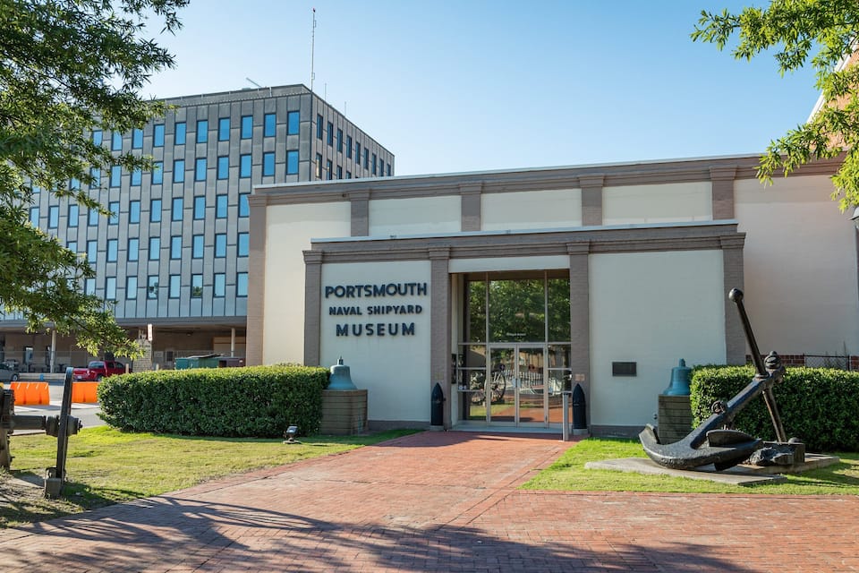 A building labeled "Portsmouth Naval Shipyard Museum" with a brick pathway leading to the entrance.