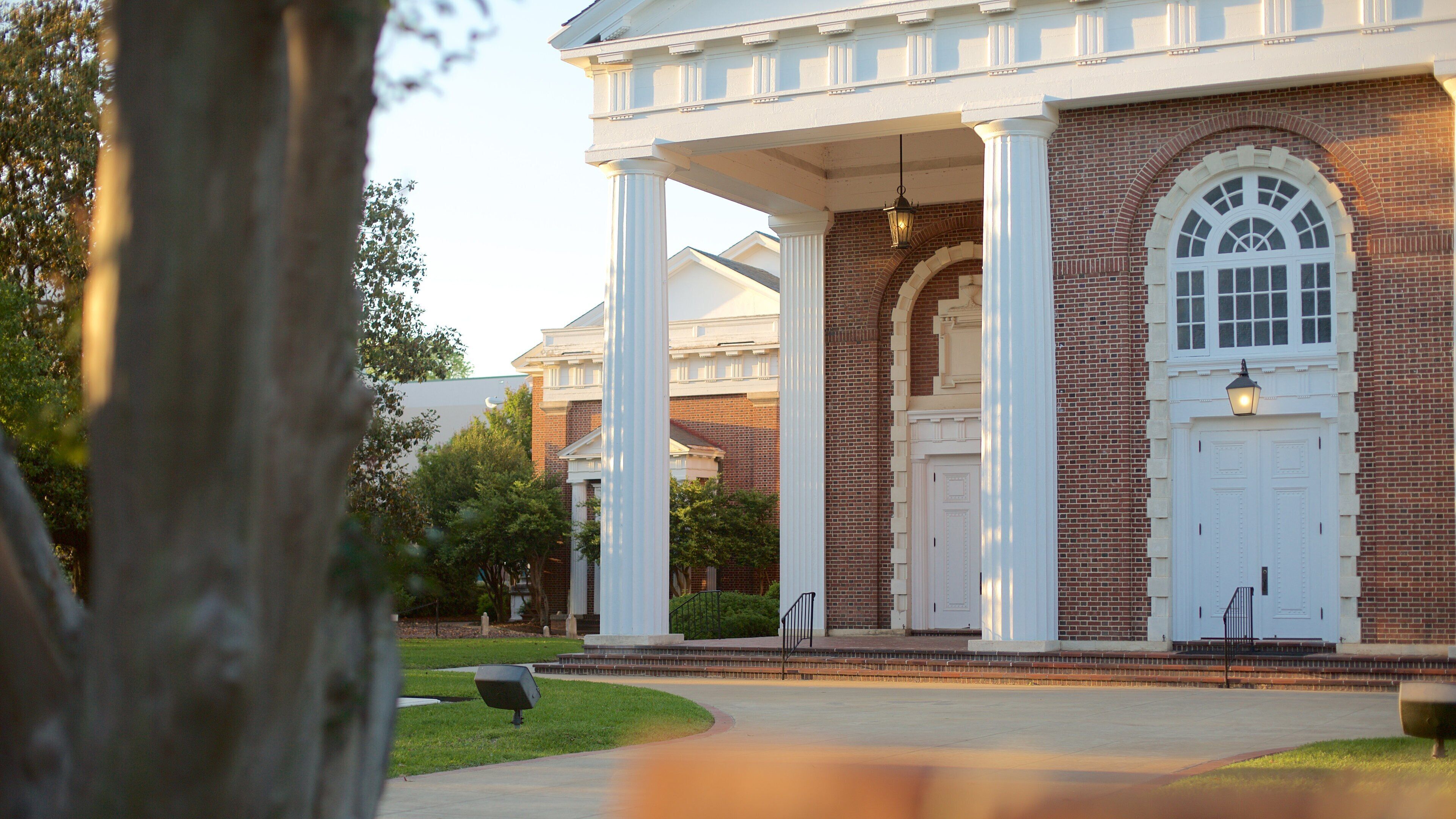 A building with white columns and a brick facade.