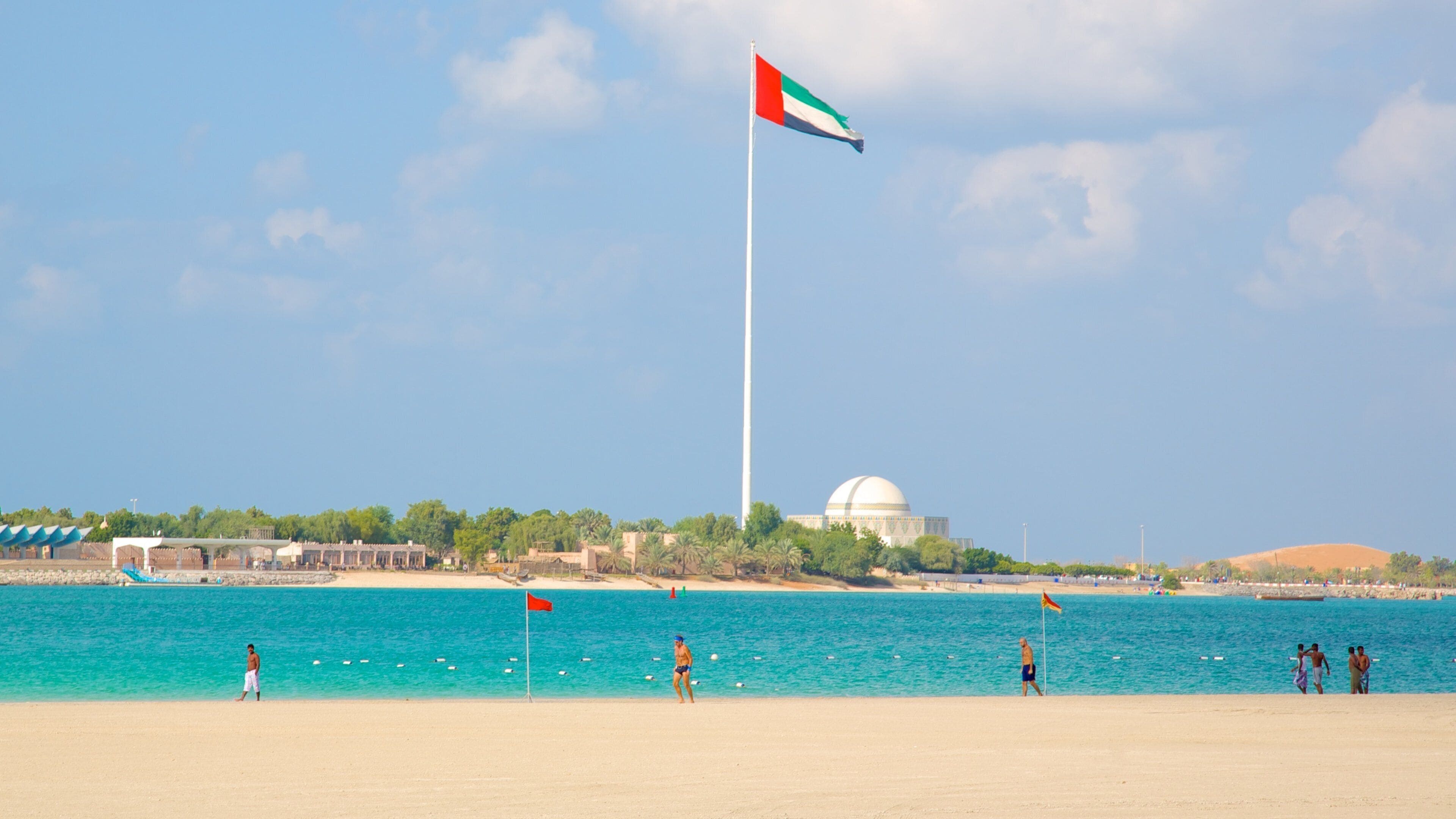 The Corniche which includes a beach, tropical scenes and general coastal views