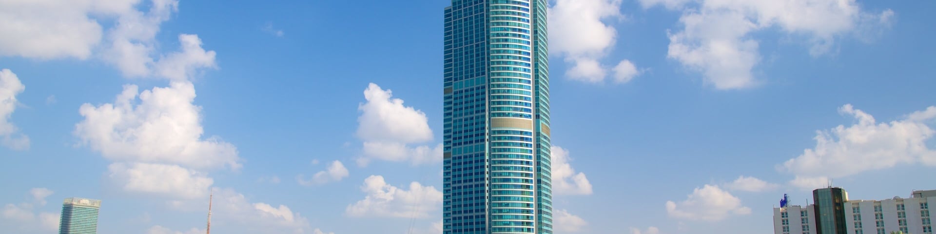 The Corniche featuring modern architecture, a bay or harbour and a high-rise building