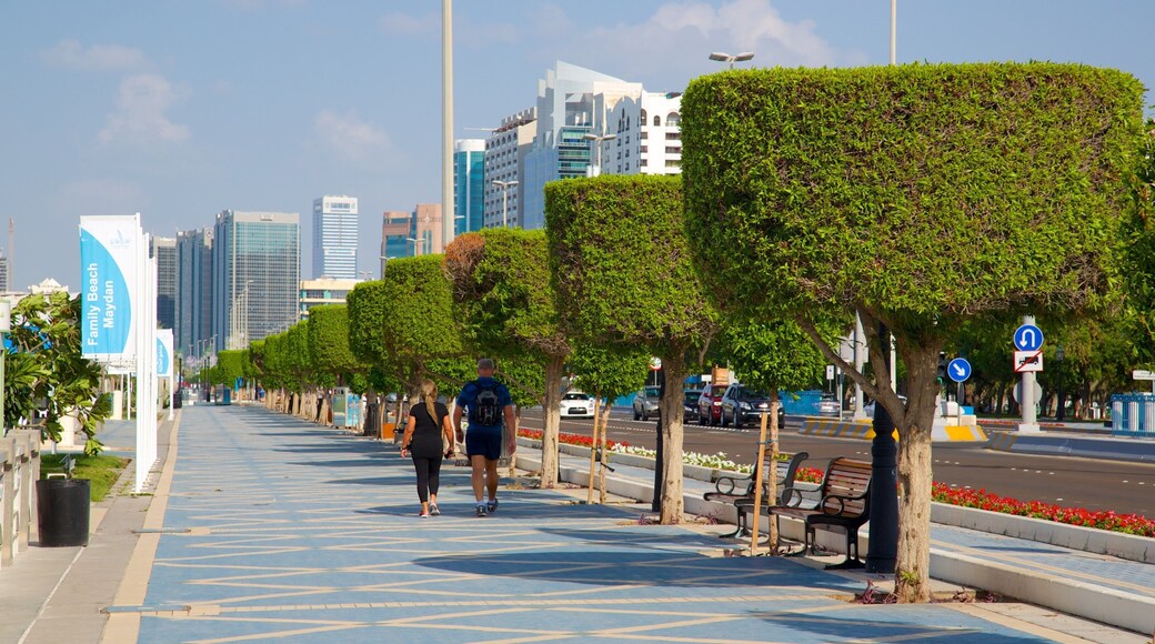The Corniche showing a city as well as a couple